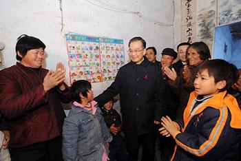 Chinese Premier Wen Jiabao (C) talks with villagers at Dahu village of Funan county, east China's Anhui Province, Nov. 29, 2008. Wen visited people living with HIV/AIDS and workers dealing with the disease in Fuyang over the weekend, prior to the World AIDS Day which falls on December 1. [Xinhua Photo] 