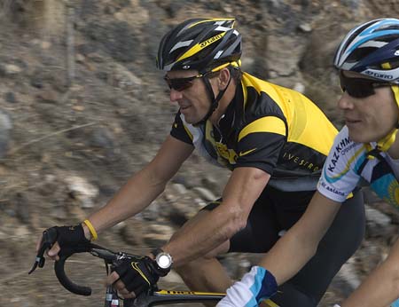 Seven-time Tour de France champion Lance Armstrong of the U.S. (L) rides during the first day of training with his new Astana cycling team in Tenerife, Spain's Canary Islands December 1, 2008.