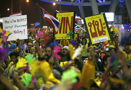 Anti-government protesters celebrate during a rally at Bangkok's Suvarnabhumi international airport December 2, 2008. Thai Prime Minister Somchai Wongsawat was banned from politics for five years and his party disbanded on Tuesday, plunging the country deeper into chaos and raising fears of a violent backlash by government supporters. [Agencies]