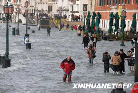 People wade through high water in Venice's St. Mark's Square, northern Italy, Monday, Dec. 1, 2008. Water in Venice has risen to its highest level in more than 20 years, leaving much of the Italian city under floods and forcing residents and tourists to wade through knee-high water. City officials say the sea level topped 156 centimeters (61 inches) on Monday, well past the 110 centimeter (40 inch) flood mark, with most streets submerged.[Xinhua/AFP] 