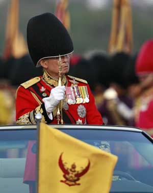 Thailand's revered King Bhumibol Adulyadej attends the annual Trooping of the Colour, an annual military parade, in Bangkok's Royal Plaza on Dec. 2, 2008.[Xinhua/Reuters]