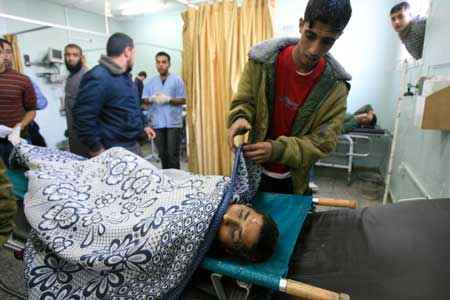 A body of the two slain Palestinians is seen at Abu Yousef al-Najjar hospital in southern Gaza Strip town of Rafah, Dec. 2, 2008. Israeli forces killed two Palestinian civilian brothers and wounded two others during an army operation in southeast Gaza Strip Tuesday afternoon, witnesses and medical sources said. [Xinhua]