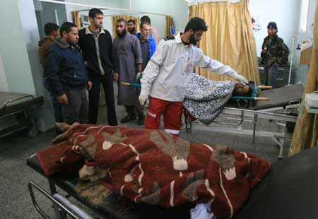 The bodies of slain Palestinians are seen at Abu Yousef al-Najjar hospital in southern Gaza Strip town of Rafah, Dec. 2, 2008. Israeli forces killed two Palestinian civilian brothers and wounded two others during an army operation in southeast Gaza Strip Tuesday afternoon, witnesses and medical sources said. [Xinhua]