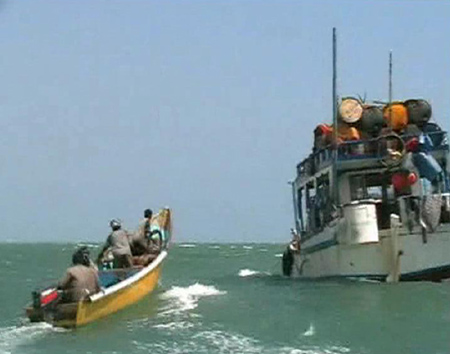 Pirates on speedboat approach one of their mother boats docked near Eyl, Somalia in this framegrab made from a November 24, 2008 TV footage. The enclave of Eyl is the homeground of pirates who are wreaking havoc on the waters off the coast of Somalia. Experts say that more than a dozen ships are still being held by pirates by the end of November, with dozens others having paid massive ransom for their freedom. [China Daily via Agencies]