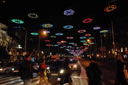 People walk on the street decorated with Christmas lamps in Madrid, capital of Spain, Dec. 2, 2008.[Chen Haitong/Xinhua]