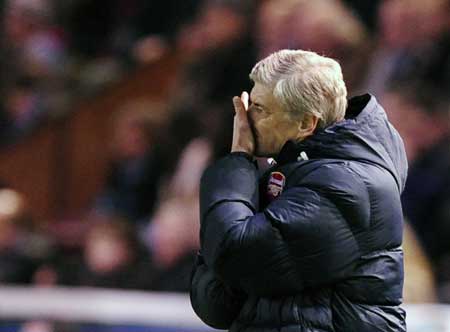 Arsenal's coach Arsene Wenger gestures during their English League Cup soccer match against Burnley in Burnley, northern England Dec. 2, 2008. 