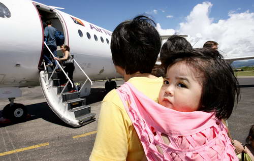 Some Chinese board a plane at Honiara, the capital of Solomon Islands, preparing to return to China. In 2006 China carried out evacuations from the Solomon Islands, East Timor, Lebanon, and Tonga because of continuous riots and armed conflicts. Officials from the Foreign Ministry said a joint mechanism had been established to provide for the protection of overseas Chinese.