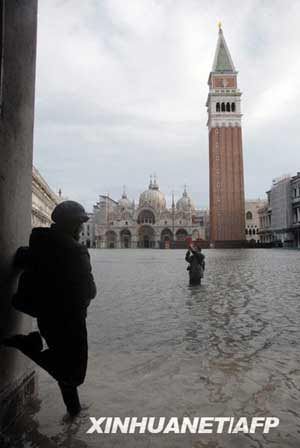 People wade through high water in Venice's St. Mark's Square, northern Italy, Monday, Dec. 1, 2008.