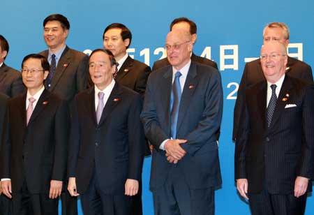 Chinese Vice Premier Wang Qishan (2nd L Front) and U.S. Treasury Secretary Henry Paulson (2nd R Front), both as special representatives of the presidents of the two countries, pose for photos before the opening ceremony of the Fifth China-US Strategic Economic Dialogue in Beijing, capital of China, Dec. 4, 2008. [Xinhua]