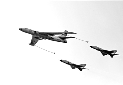 Fighter jets conduct in-flight refueling.