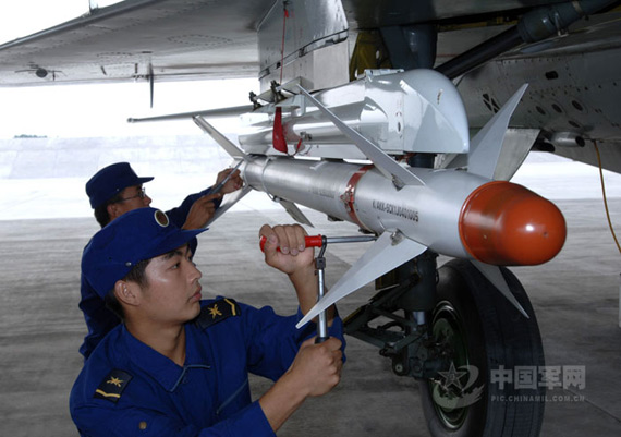 Engineers load fighters with PL-9C air-to-air missiles.