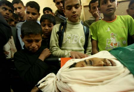 School friends of Palestinian Ramzi al-Duhimi, 17, attend his funeral in southern Gaza Strip town of Rafah, Dec. 3, 2008. Ramzi was killed with another boy during an Israeli attack in southeast Gaza Strip on Tuesday.[Xinhua]