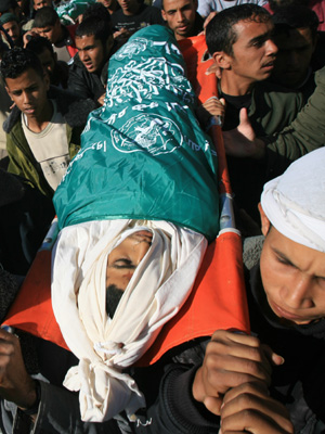 School friends of Palestinian Ramzi al-Duhimi, 17, attend his funeral in southern Gaza Strip town of Rafah, Dec. 3, 2008. Ramzi was killed with another boy during an Israeli attack in southeast Gaza Strip on Tuesday.[Xinhua]