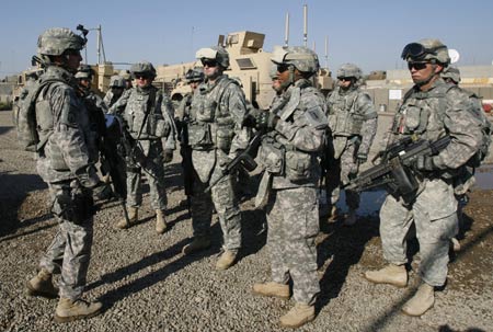A U.S. military officer (L) of 2nd Heavy Brigade Combat Team, 1st Infantry Division briefs his platoon before a meeting with Iraqi military officers and local tribal leaders in the Hurriya district northwest of Baghdad December 3, 2008. U.S. military officers asked local tribal leaders to convince Sunni refugees who fled their homes due to sectarian violence to return to their area, during a meeting in a mosque on Wednesday, a local government official said.[Xinhua/Reuters]