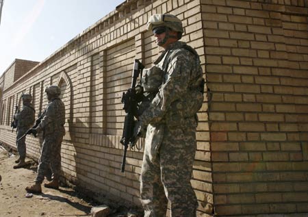 U.S. soldiers of 2nd Heavy Brigade Combat Team, 1st Infantry Division stands guard outside a mosque in the Hurriya district northwest of Baghdad December 3, 2008.[Xinhua]