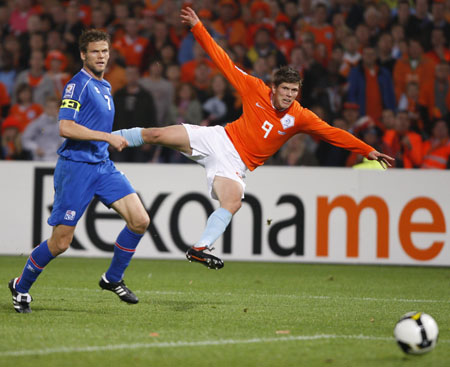 Netherlands' Klaas Jan Huntelaar (R) scores past Iceland's Hermann Hreidarsson during their 2010 World Cup qualifying soccer match in Rotterdam, Oct.11, 2008.  