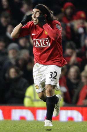 Manchester United's Carlos Tevez celebrates his second goal against Blackburn Rovers during their English League Cup soccer match at Old Trafford in Manchester, northern England, Dec. 3, 2008. 