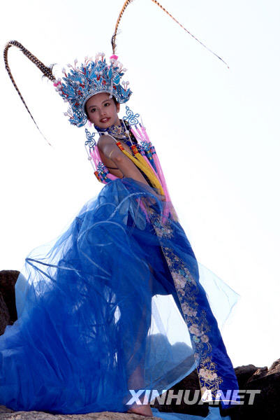 A competitor displays a wedding dress during China 2008 Xinsilu model contest in Sanya of south China's Hainan Province, Dec. 2, 2008.