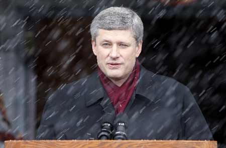 Canada's Prime Minister Stephen Harper pauses while speaking as sleet falls at Rideau Hall in Ottawa December 4, 2008 following his meeting with Governor General Michaelle Jean. [Xinhua/Reuters]