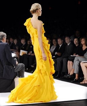 This Monday, sept. 8, 2008 file photo shows the spring 2009 collection of Carolina Herrera modeled during Fashion Week in New York. Pantone, which provides color standards to design industries, specifically cites mimosa, a vibrant shade illustrated by the flowers of the mimosa tree as well as the brunch-favorite cocktail, as its top shade of the new year, but the company, in general, believes the public will embrace many tones of optimistic yellow.