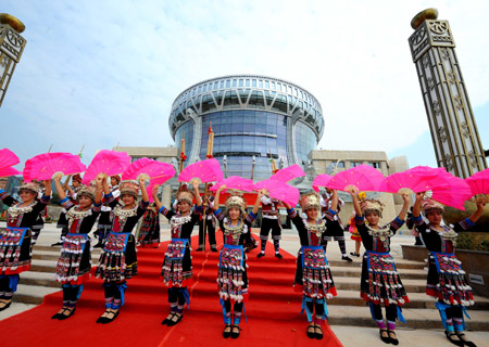 Performers dance during a rehearsal of the opening ceremony in front of the Museum of Nationalities in Nanning, capital of southwest China's Guangxi Zhuang Autonomous Region, on Dec. 5, 2008.