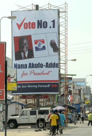 People walk pass a poster of Nana Addo Dankwa Akufo-Addo, presidential candidate of the ruling New Patriotic Party (NPP) in Accra, capital of Ghana, on Dec. 5, 2008. Ghana will hold presidential election on Dec. 7, 2008. [Xinhua]