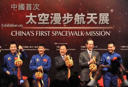 Three taikonauts of the Shenzhou VII manned space mission, Zhai Zhigang (right), Liu Boming (second from left) and Jing Haipeng (left), taikonauts' delegation head Zhang Jianqi (middle) and Hong Kong Special Administrative Region (HKSAR) government's Chief Secretary for Administration Henry Tang cut the ribbon at the opening ceremony of a spacewalk mission exhibition at the Hong Kong Science Museum on Saturday, December 6, 2008. (Xinhua 
