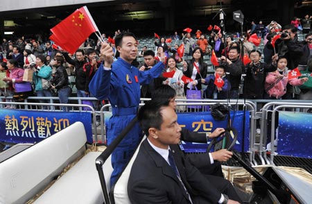 Chinese taikonaut Liu Boming waves to the audience during a gala in Hong Kong, south China, on Dec. 7, 2008.