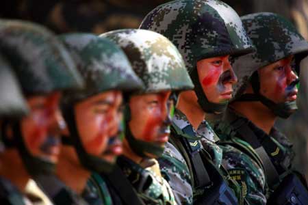 Chinese soldiers react during an exercise on the second day of the China-India army joint anti-terrorism training code-named 'Hand in Hand 2008' in Belgaum, India, Dec. 7, 2008. The week-long China-India army joint anti-terrorism training entered the second phase on Sunday, as soldiers from the two sides began to carry out exercise together. (Xinhua