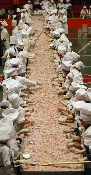 Peruvian chefs, elbow deep in more than six tonnes of square-cut fish, onion and lime, won on Sunday the Guinness World Record for preparing the largest ceviche, a Peruvian seafood specialty. The classic dish, made with raw fish and a spicy citrus sauce that 'cooks' it, weighed in at 6.8 tonnes, some 2 tonnes more than the previous record.