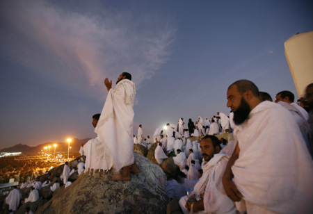 Muslim pilgrims pray on Mount Mercy on the plains of Arafat outside the holy city of Mecca December 7, 2008. More than two million Muslims began the haj pilgrimage on Saturday, heading to a tent camp outside Mecca to follow the route Prophet Mohammad took 14 centuries ago. [Agencies via China Daily] 