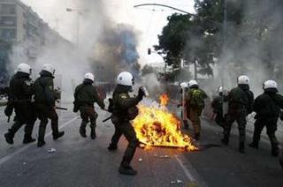 A policeman throws a tear gas against protesters during riots in Athens December 7, 2008. [Yiorgos Karahalis/REUTERS]