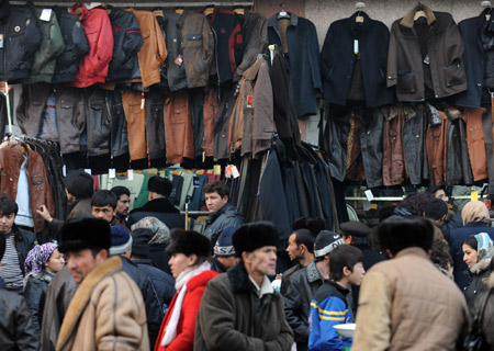 Muslims shop for new clothes at a market in Urumqi, capital of northwest China's Xinjiang Uygur Autonomous Region, on Dec. 8, 2008. 