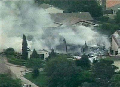 This video frame grab image taken from KGTV television shows the scene where an F18 military jet crashed in a San Diego neighborhood, Monday December, 8, 2008, sparking at least one house fire. [Agencies] 