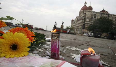  Candles and flowers placed for victims of the Mumbai attacks are seen in front of the Taj Mahal Hotel in Mumbai November 30, 2008.