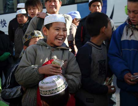 A Chinese Muslim boy laughs during celebrations in Yinchuan, northwest China's Ningxia Hui Autonomous Region, on Dec. 9, 2008. Muslims of Ningxia Hui Autonomous Region celebrated on Tuesday the Eid al-Adha festival, which falls on Dec. 9 this year. (Xinhua/Wang Peng