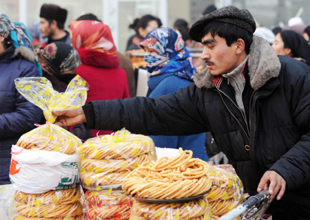 A Muslim man shops for food at a market in Urumqi, capital of northwest China's Xinjiang Uygur Autonomous Region, on Dec. 8, 2008.