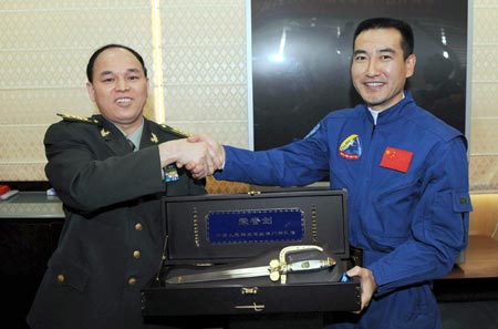 Xu Jinlin (L), political commissar of the Chinese People's Liberation Army Garrison in the Macao Special Administrative region, shakes hands with Chinese taikonaut Zhai Zhigang in Macao on Dec. 9, 2008. [Xinhua] 