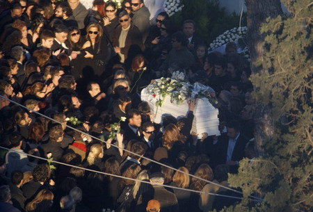 Mourners carry the coffin of Alexandros Grigoropoulos, 15, during his funeral in Athens December 9, 2008. Riot police fought running battles with hundreds of protestors outside Greece's parliament on Tuesday while the opposition socialist party called for elections to end four days of protests.