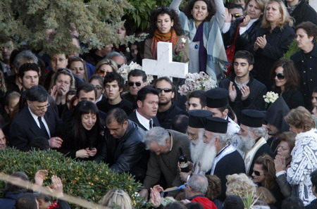 Mourners attend the funeral of Alexandros Grigoropoulos, 15, who was killed by police several days ago in Athens December 9, 2008. Riot police fought running battles with hundreds of protestors outside Greece's parliament on Tuesday while the opposition socialist party called for elections to end four days of protests.