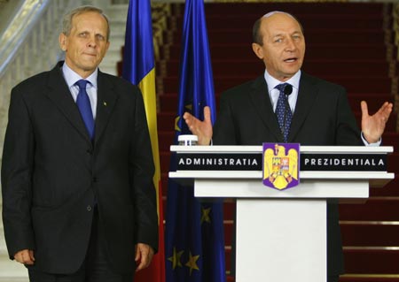 Romanian President Traian Basescu speaks in Bucharest, Romania, on Wednesday, Dec. 10, 2008. Basescu named Theodor Stolojan (L), vice president of the centrist Democratic Liberal Party (PD-L), as the country's new prime minister. [Xinhua/Reuters]