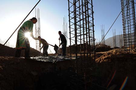 Residents work at the construction site in Luobozhai Village of Yanmen Township, the quake-hit Wenchuan County, southwest China's Sichuan Province, Dec. 8, 2008. 