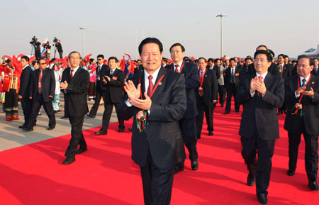 Zhou Yongkang(C front), member of the Standing Committee of the Political Bureau of the Communist Party of China (CPC) Central Committee, arrives in Nanning to attend celebrations marking the 50th founding anniversary of the Guangxi Zhuang Autonomous Region in Nanning, capital of southwest China's Guangxi Zhuang Autonomous Region, on Dec. 10, 2008.[Liu Weibing/Xinhua]