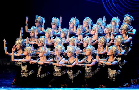 Stagers perform at a gala show in Nanning, capital of southwest China's Guangxi Zhuang Autonomous Region, Dec. 10, 2008. The song and dance show highlighted rich cultural heritage of local ethnic groups, as well as beautiful landscape such as green mountains and the Lijiang River in Guilin, which makes Guangxi a world-famous tourist destination. It's one of the activities marking the 50th founding anniversary of the Guangxi Zhuang Autonomous Region. [Xinhua]