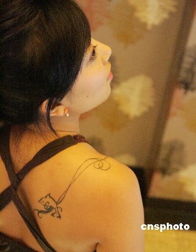 A Shanghai lady with a tattoo on her back. Tattoos have become very popular 