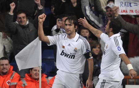 Real Madrid's Raul Gonzalez (L) celebrates a goal against Zenit Saint Petersburg with his team mate Marcelo during their Champions League soccer match in Madrid December 10, 2008. Juande Ramos began his time as Real Madrid coach with a straightforward 3-0 win at home to Zenit Saint Petersburg in the Champions League on Wednesday night. [Xinhua/Reuters]