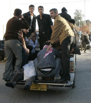 A police vehicle transports bomb attack victims to a hospital in Kirkuk, 250 km (155 miles) north of Baghdad December 11, 2008.