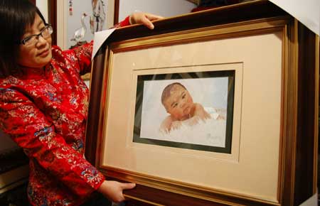 Handicrafts woman Pu Fengjuan shows her embroidery work in Suzhou city, east China's Jiangsu Province, Dec. 11, 2008. 