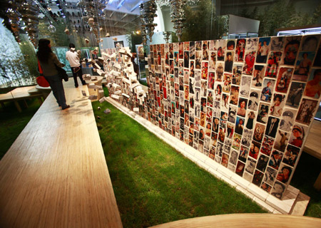 Visitors look at works of Chinese artist Wen Fang during an exibition held at the Ullens Center for Contemporary Art at the 798 Art Zone in Beijing, capital of China, Dec. 10, 2008. The exhibition, 'Christian Dior and Chinese Artists', featured over 100 Dior Couture pieces from Paris and works of 20 contemporary Chinese artists. The show symbolizes an open dialogue between two different means of expression, contemporary art and fashion.