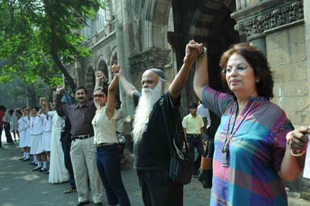 People form a human chain along a street in Mumbai, India, Dec. 12, 2008. Thousands of Mumbai residents formed a human chain snaking through the city on Friday near the attacked sites including Taj Mahal Hotel, Oberoi Trident Hotel and the Mumbai CST railway station, protesting the devastating attacks that left at least 195 dead last month. 